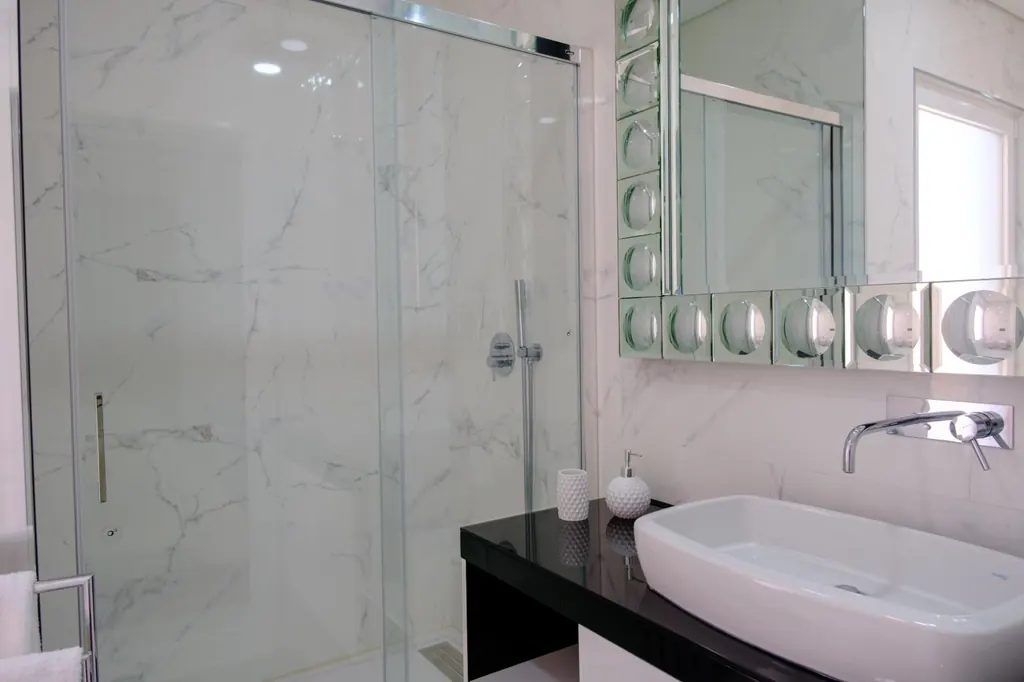 Bathroom with walk-in shower and marble finishes